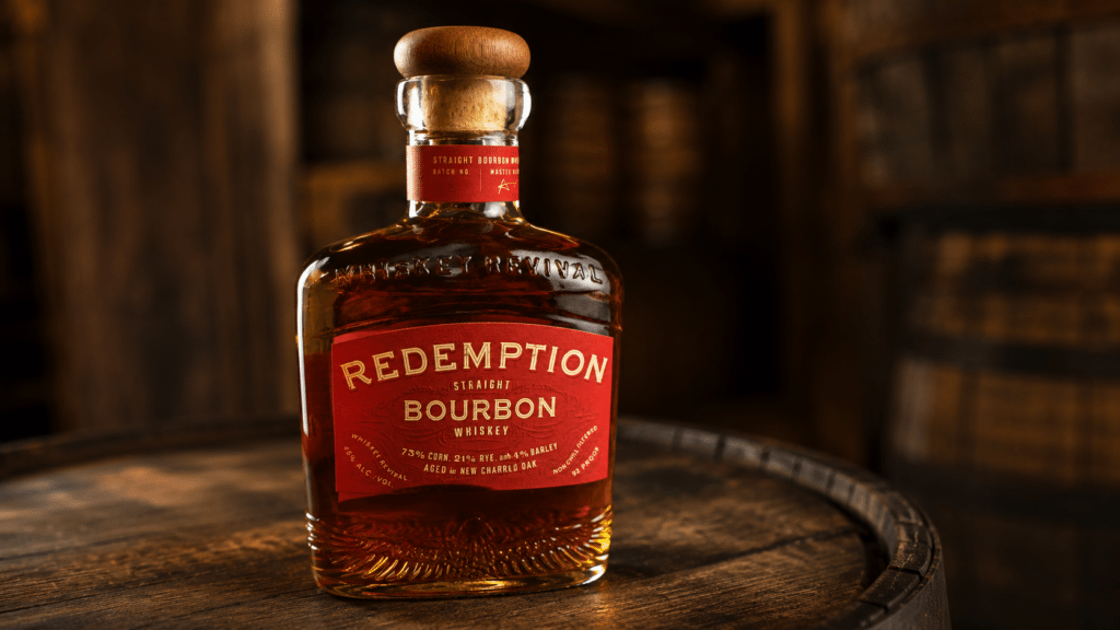 Redemption Bourbon bottle on a rustic wooden barrel